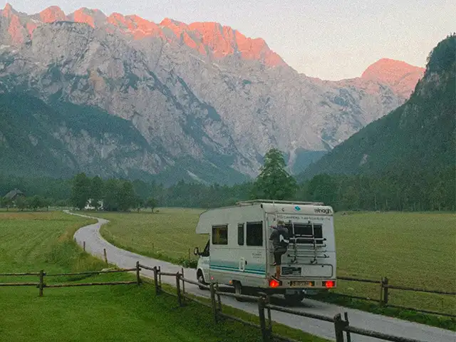 RV and Marine Lithium Battery Applications Motorhome on a rural road with mountains behind, an application for RV and marine lithium batteries